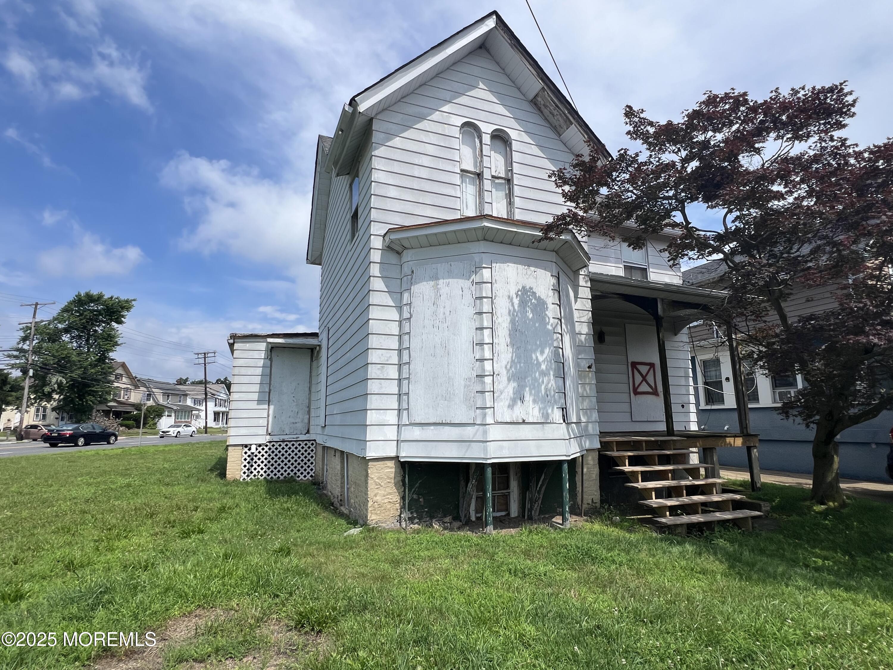 a front view of a house with a garden