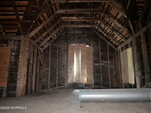 a view of water heater room with stairs