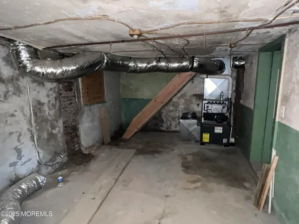 a view of water heater room with stairs