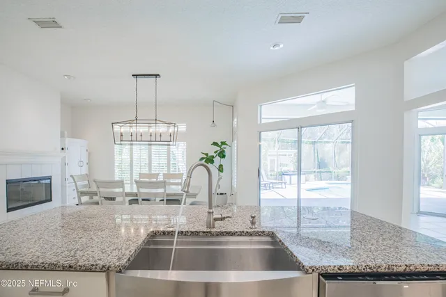 a kitchen with granite countertop a sink and a window
