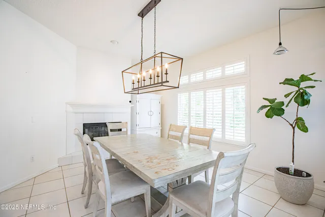 a view of a dining room with furniture and a potted plant