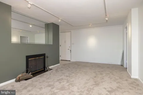 a view of an empty room with a fireplace
