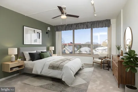a bedroom with a large bed and a large window