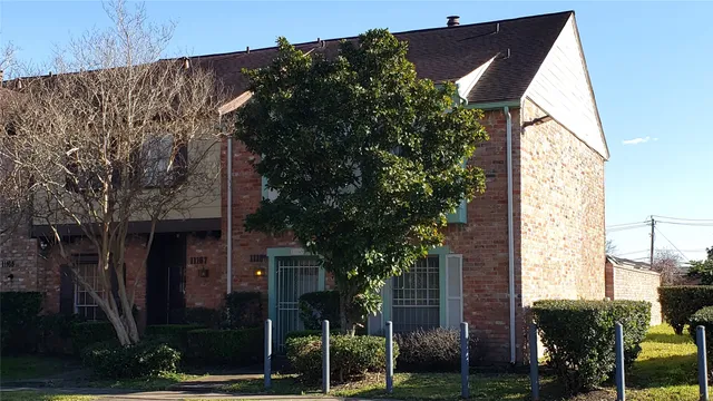 front view of a house with a tree