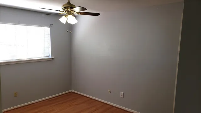 a small space with a window and a fan