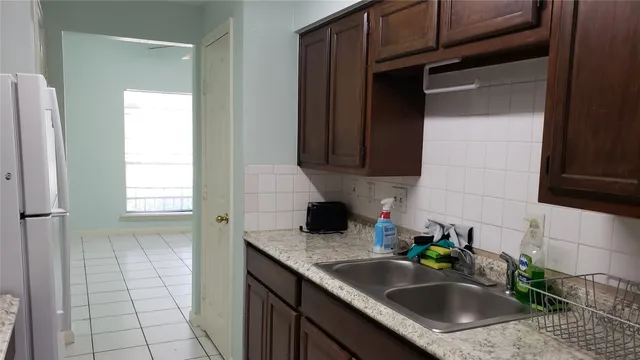 a kitchen with a sink and cabinets