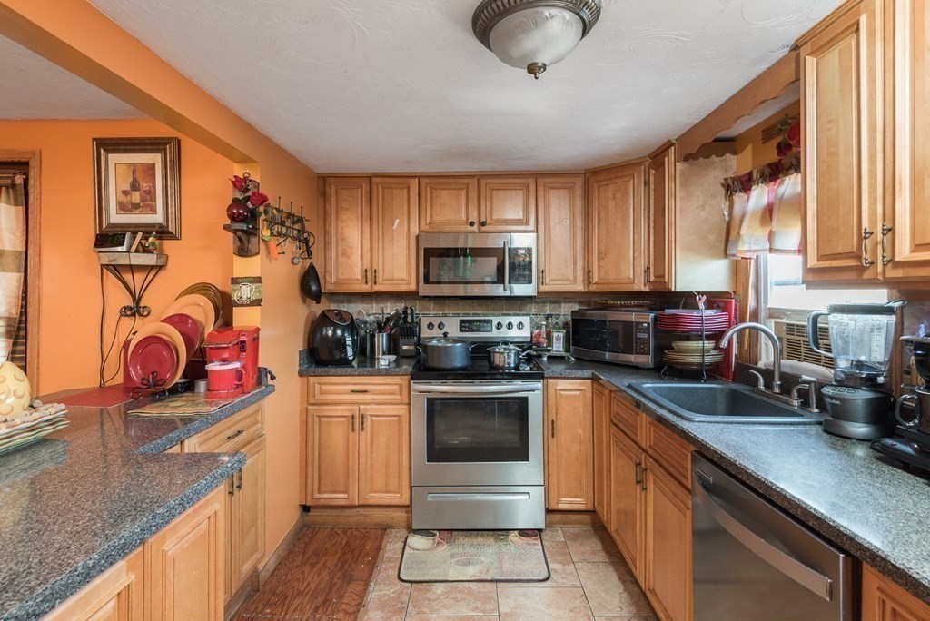 14 Sumner Street Taunton, MA 02780 - Photo 14 of 22 a kitchen with stainless steel appliances granite countertop a stove sink and cabinets