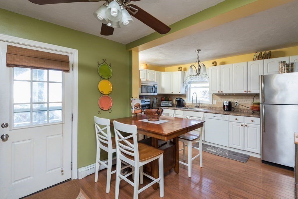 14 Sumner Street Taunton, MA 02780 - Photo 6 of 22 a kitchen with a dining table chairs stainless steel appliances and cabinets