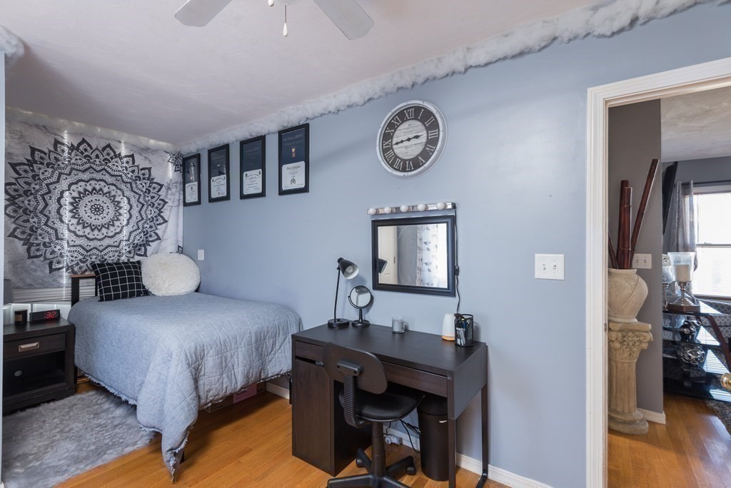 14 Sumner Street Taunton, MA 02780 - Photo 10 of 22 a bedroom with a bed and a chandelier