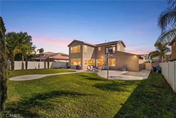 a view of a house with a big yard and a large tree