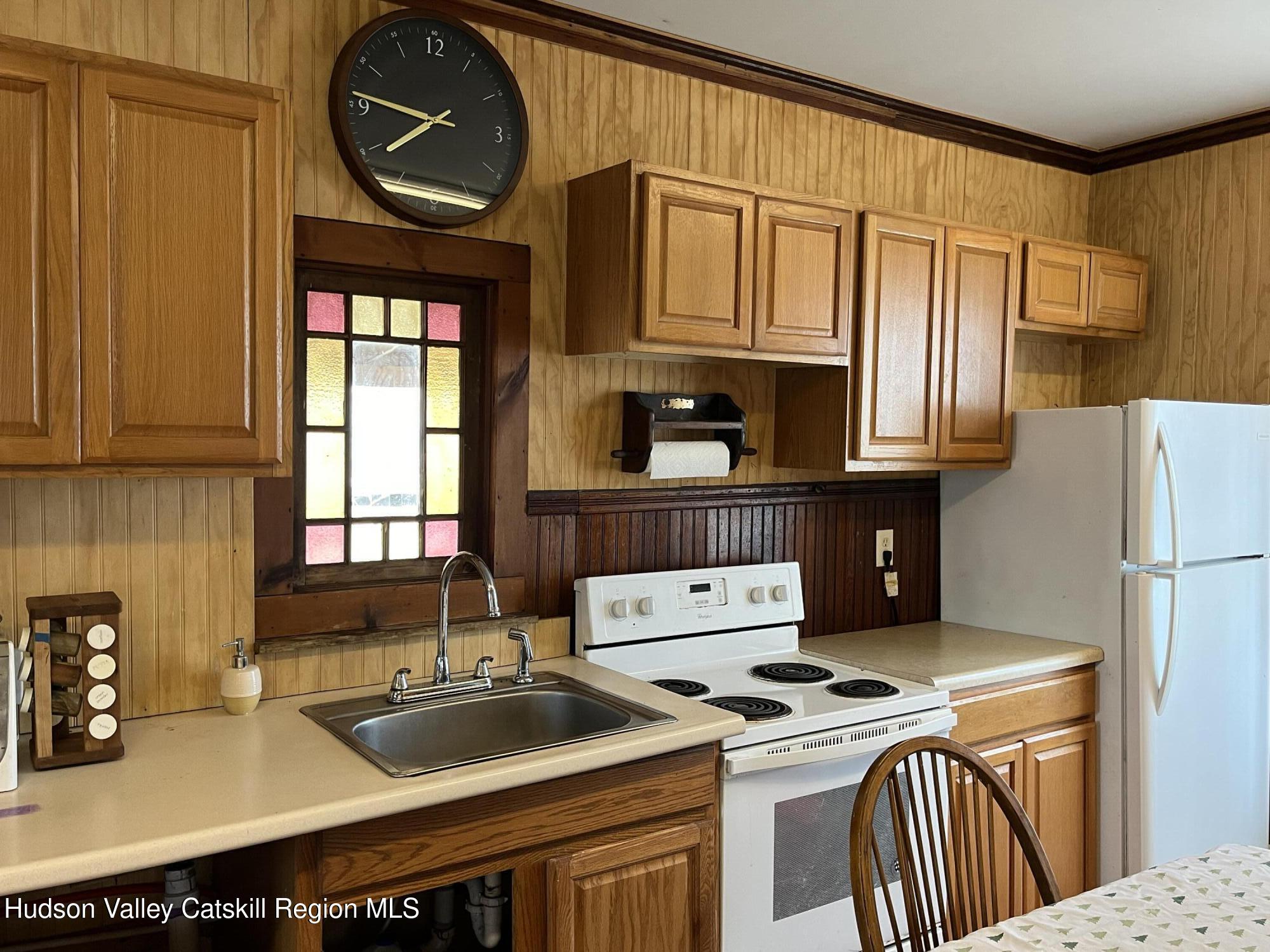 311 North Lake Road Haines Falls, NY 12436 - Photo 4 of 34 a kitchen with a sink stove and microwave