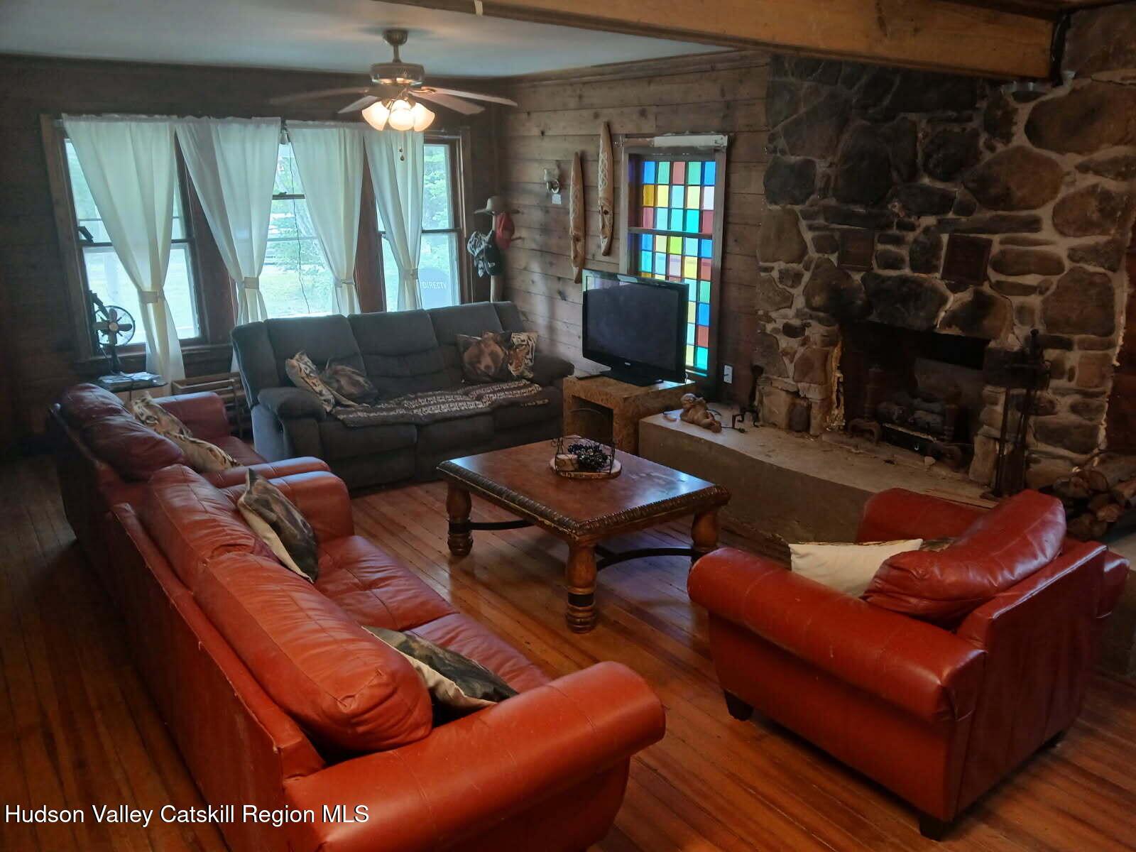 311 North Lake Road Haines Falls, NY 12436 - Photo 6 of 34 a living room with furniture a lamp and a large window