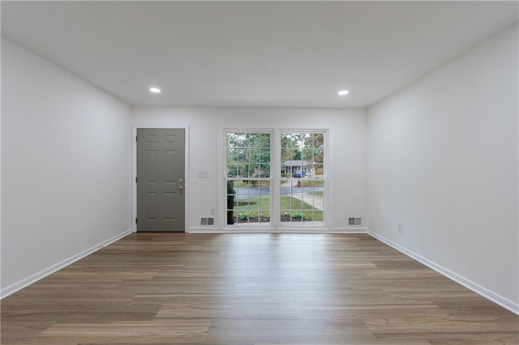 4360 Sasanqua Court Tucker, GA 30084 - Photo 14 of 37 a view of an empty room with wooden floor and a window