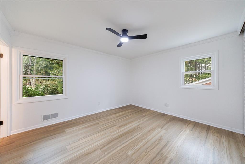 4360 Sasanqua Court Tucker, GA 30084 - Photo 17 of 37 a view of an empty room with wooden floor and a window