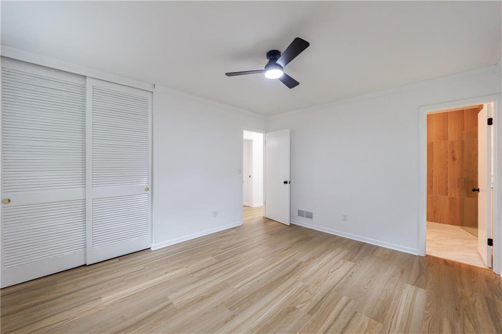 4360 Sasanqua Court Tucker, GA 30084 - Photo 18 of 37 an empty room with wooden floor cabinet and windows