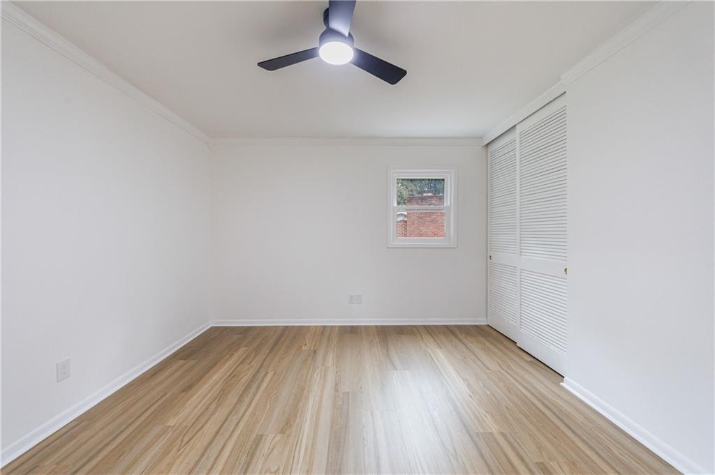 4360 Sasanqua Court Tucker, GA 30084 - Photo 19 of 37 an empty room with wooden floor and windows
