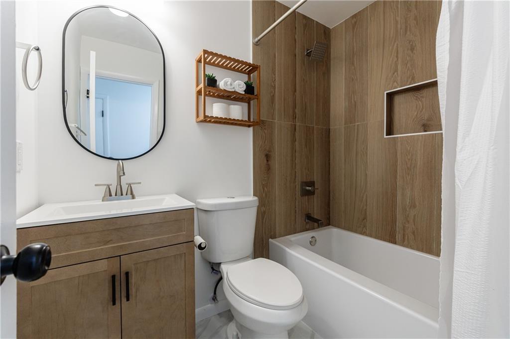 4360 Sasanqua Court Tucker, GA 30084 - Photo 24 of 37 a bathroom with a toilet a sink and a mirror