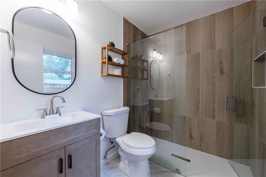 4360 Sasanqua Court Tucker, GA 30084 - Photo 26 of 37 a bathroom with a toilet sink and mirror