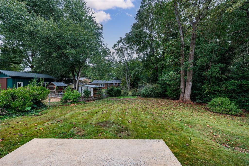 4360 Sasanqua Court Tucker, GA 30084 - Photo 31 of 37 a view of a backyard with potted plants and large trees