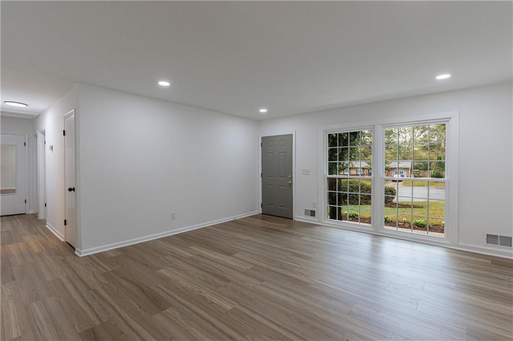 4360 Sasanqua Court Tucker, GA 30084 - Photo 6 of 37 a view of an empty room with wooden floor and a window