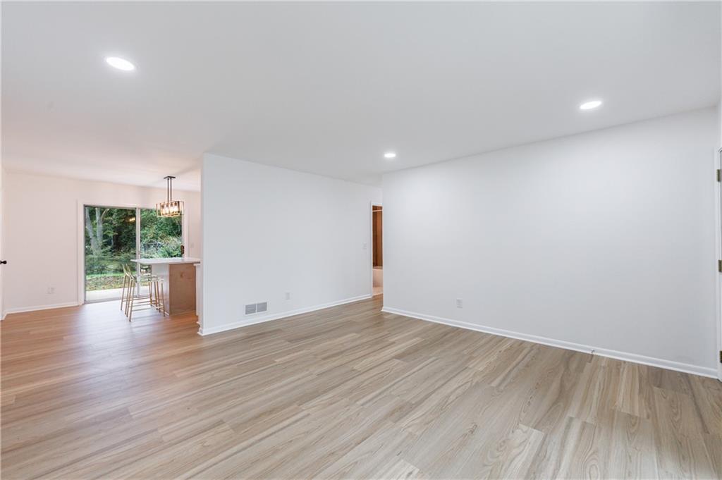 4360 Sasanqua Court Tucker, GA 30084 - Photo 8 of 37 a view of an empty room with wooden floor and a window