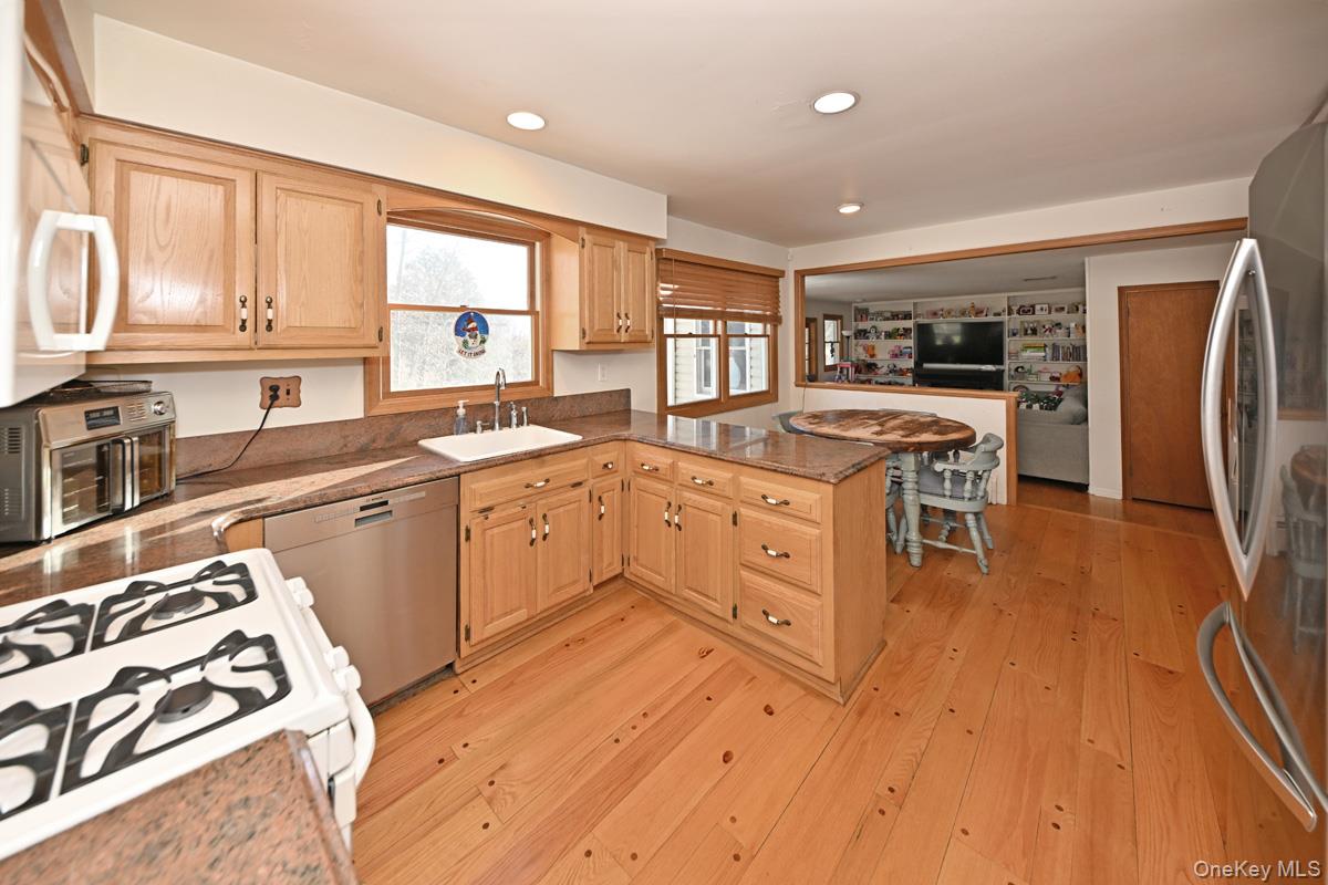 7 Lexington Road New City, NY 10956 - Photo 12 of 36 Kitchen featuring a peninsula, stainless steel appliances, light wood-style floors, light brown cabinetry, and recessed lighting