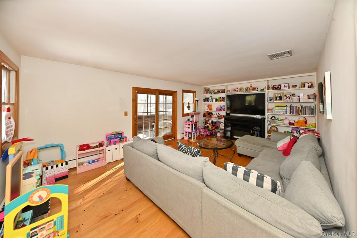 7 Lexington Road New City, NY 10956 - Photo 18 of 36 Living area with wood finished floors and built in shelves