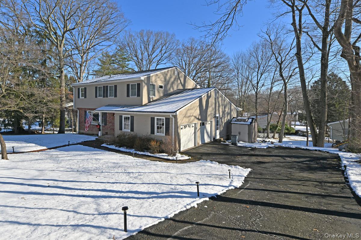 7 Lexington Road New City, NY 10956 - Photo 2 of 36 View of front of house with driveway, brick siding, and an attached garage