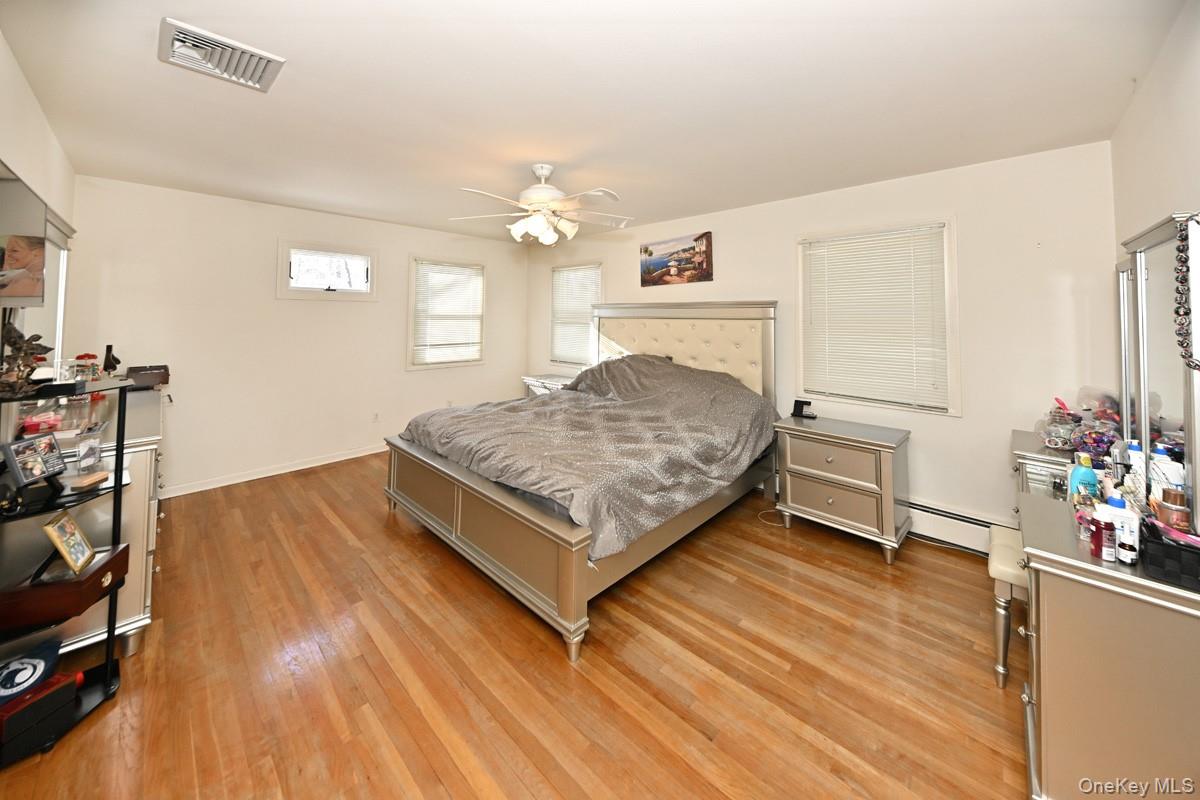 7 Lexington Road New City, NY 10956 - Photo 26 of 36 Bedroom featuring a ceiling fan, light wood-type flooring, and a baseboard heating unit