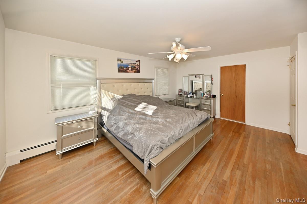 7 Lexington Road New City, NY 10956 - Photo 27 of 36 Bedroom with light wood-type flooring, a ceiling fan, and a baseboard heating unit