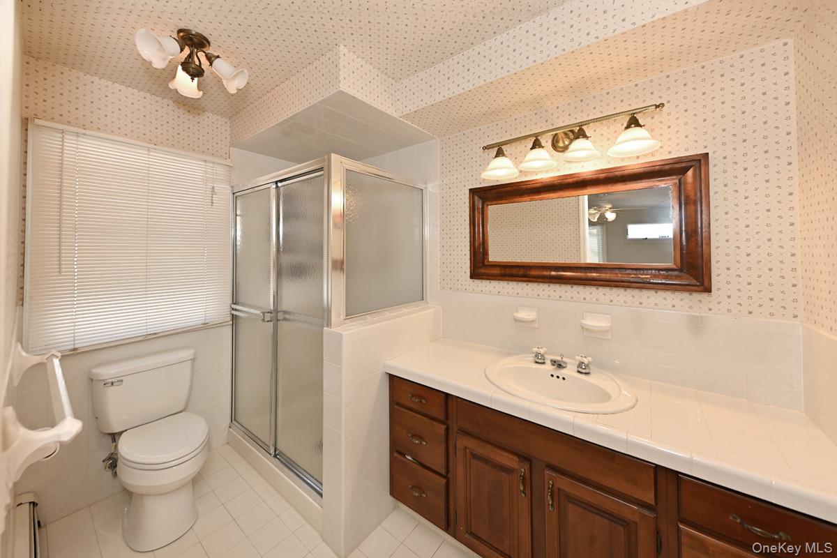7 Lexington Road New City, NY 10956 - Photo 31 of 36 Bathroom featuring vanity, a shower stall, and light tile patterned floors