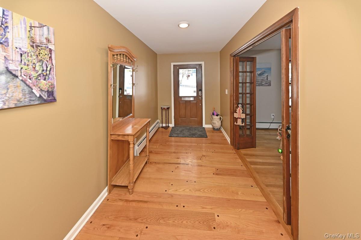 7 Lexington Road New City, NY 10956 - Photo 10 of 36 Doorway to outside featuring hardwood / wood-style floors, a baseboard radiator, french doors, and recessed lighting