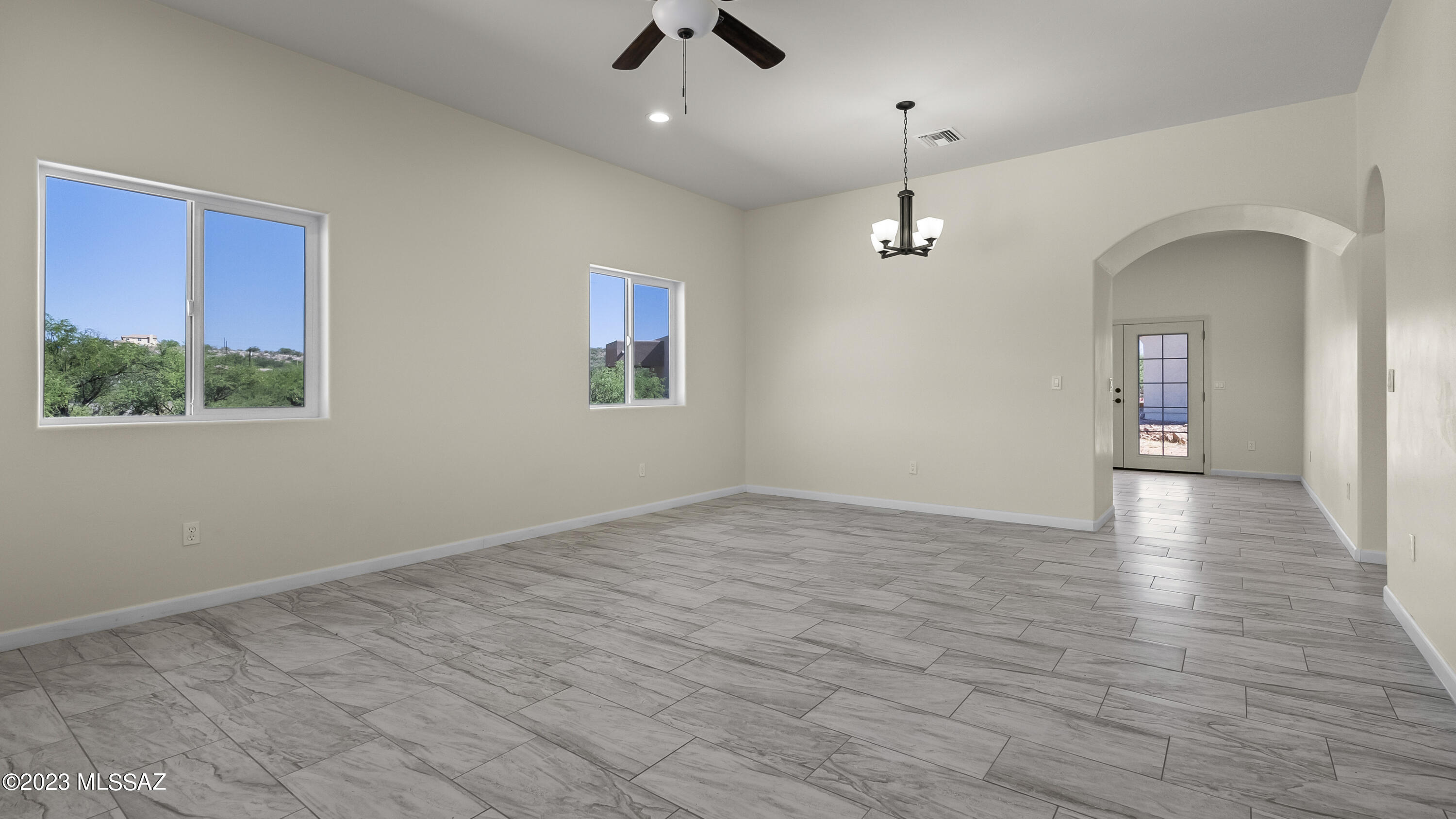 1799 Saltillo Court Rio Rico, AZ 85648 - Photo 3 of 25 wooden floor in an empty room with a window
