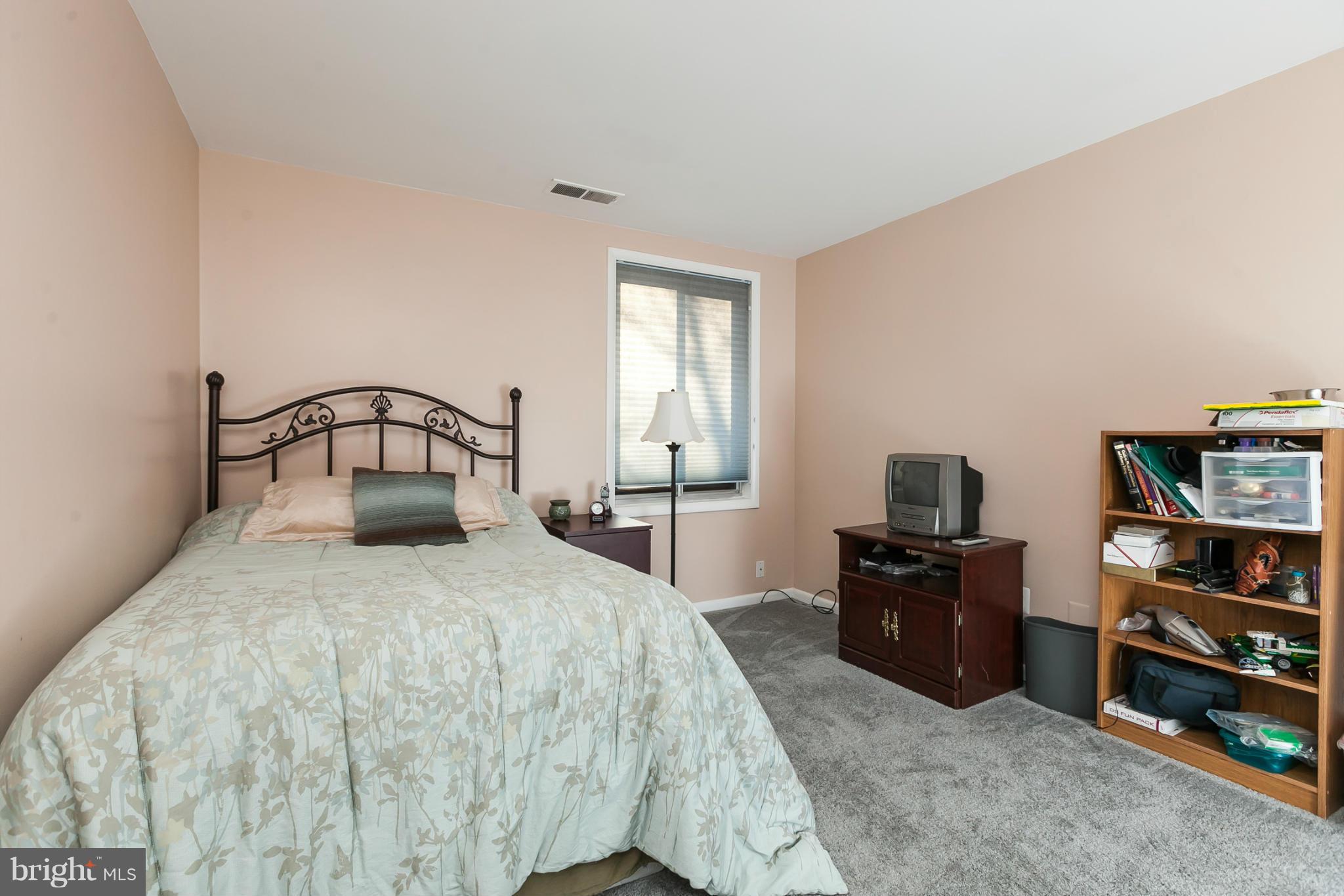 16 Cross Keys Road, Unit 16D Baltimore, MD 21210 - Photo 17 of 29 a bedroom with a bed and a television
