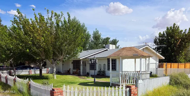 a front view of a house with a yard table and chairs