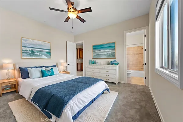 a spacious bedroom with a bed and a chandelier