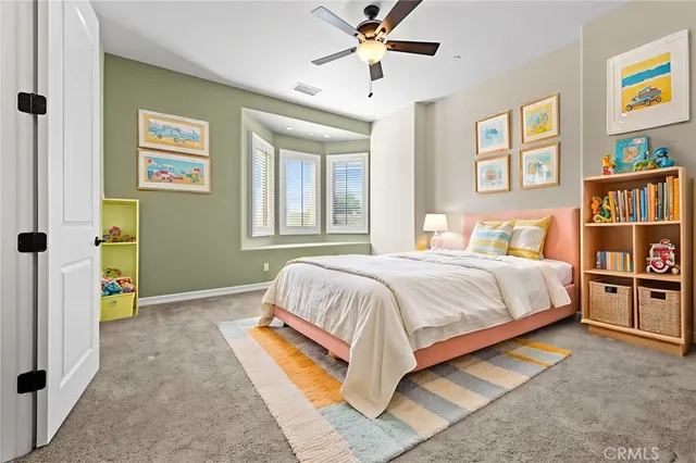 a bedroom with a bed and a book shelf