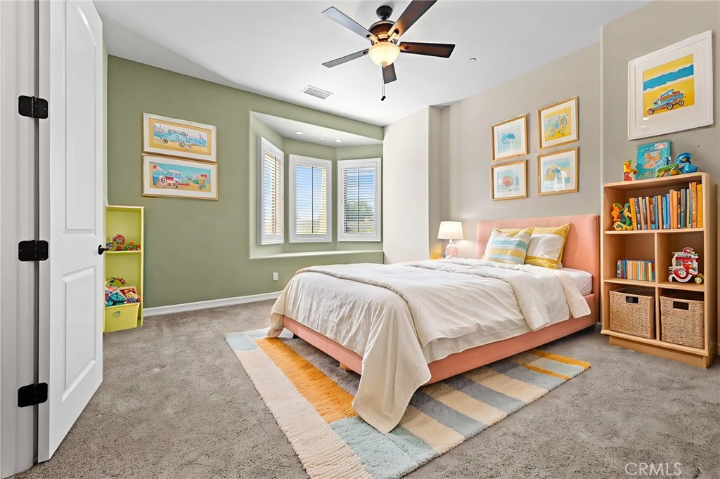 670 Pinnacle Ridge Road Riverside, CA 92506 - Photo 12 of 75 a bedroom with a bed and a book shelf