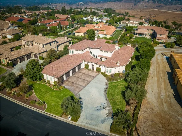 an aerial view of residential houses with outdoor space and swimming pool