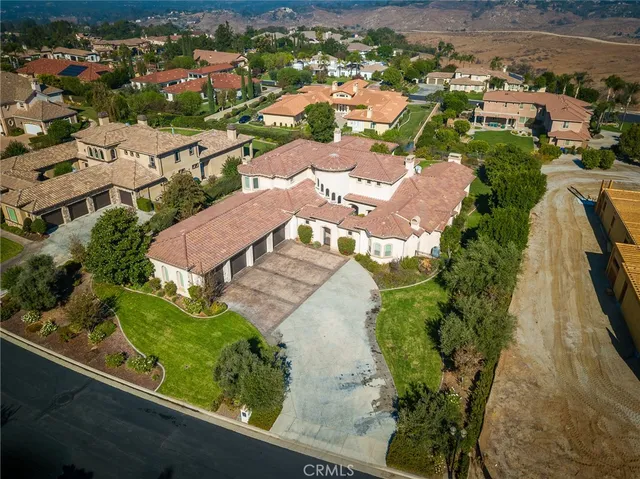 an aerial view of residential houses with outdoor space and swimming pool