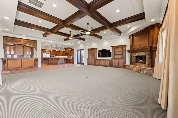 a kitchen with granite countertop a sink a counter top space stainless steel appliances and cabinets