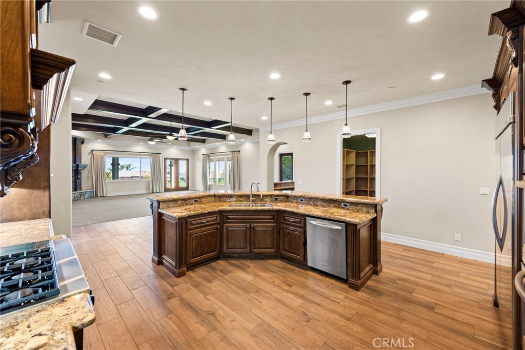 670 Pinnacle Ridge Road Riverside, CA 92506 - Photo 21 of 72 a kitchen with stainless steel appliances granite countertop a stove and a sink