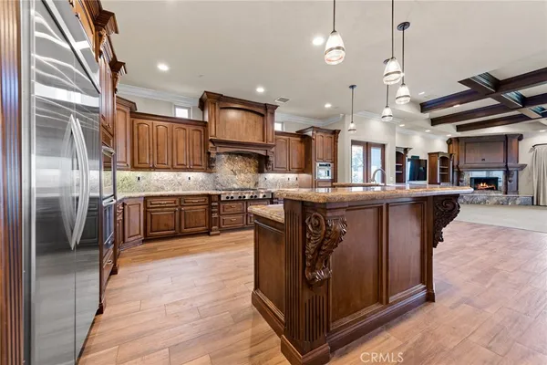 a kitchen with stainless steel appliances granite countertop a stove a sink dishwasher and a refrigerator