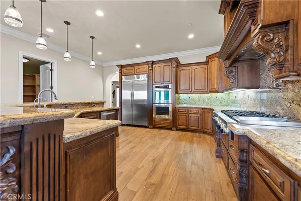 a view of a hallway with entryway windows and a chandelier