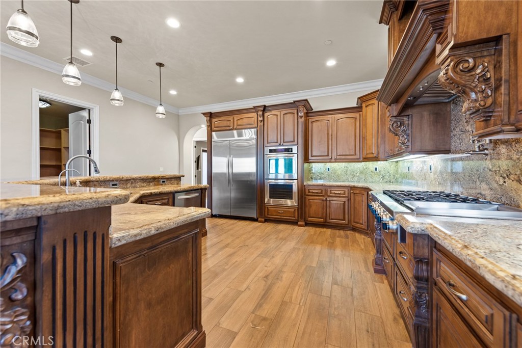 670 Pinnacle Ridge Road Riverside, CA 92506 - Photo 26 of 75 a kitchen with granite countertop a sink a counter top space stainless steel appliances and cabinets
