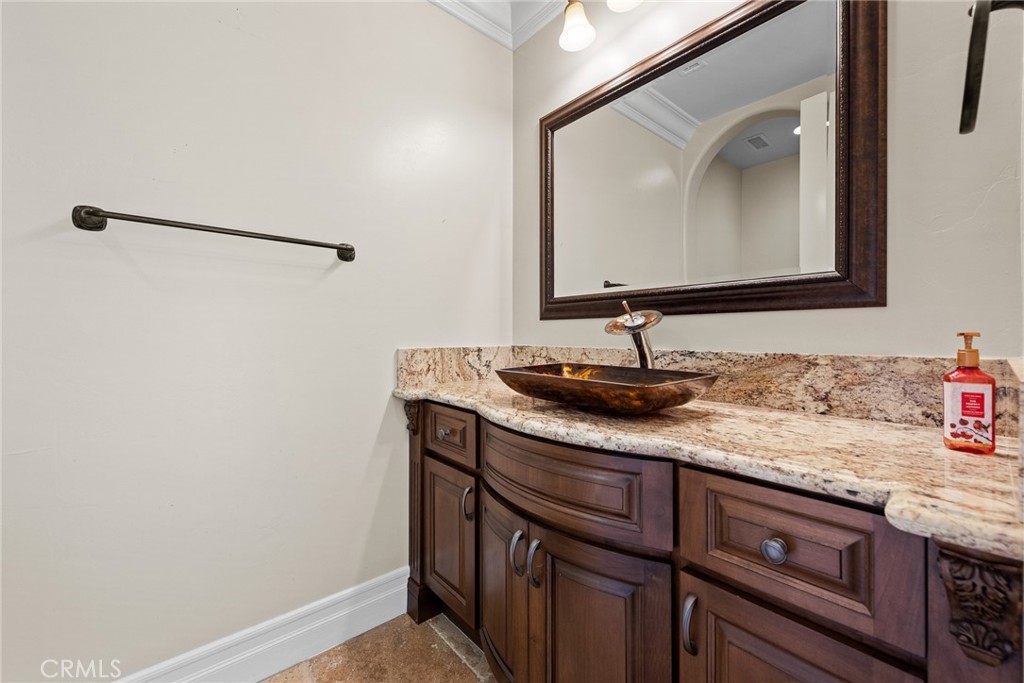 670 Pinnacle Ridge Road Riverside, CA 92506 - Photo 26 of 72 a bathroom with a granite countertop sink and a mirror