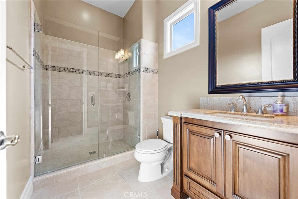 670 Pinnacle Ridge Road Riverside, CA 92506 - Photo 28 of 72 a bathroom with a granite countertop sink a toilet and shower