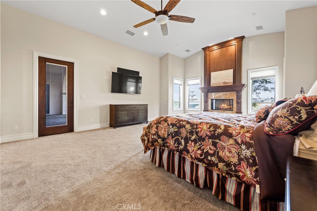 670 Pinnacle Ridge Road Riverside, CA 92506 - Photo 30 of 72 a bedroom with a bed and ceiling fan