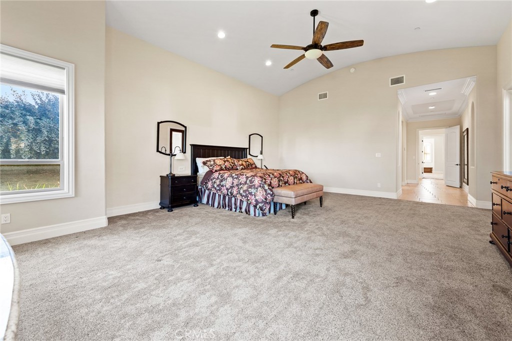 670 Pinnacle Ridge Road Riverside, CA 92506 - Photo 31 of 72 a bed room with a bed and a chandelier
