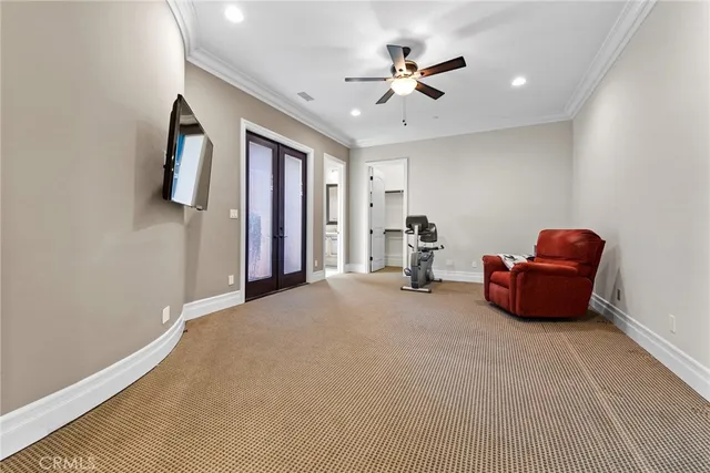 a bedroom with bed and a large window